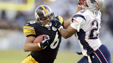 27 Jan 2002: Hines Ward #86 of the Pittsburgh Steelers tries to get past a tackle attempt by Ty Law #24 of the New England Patriots during the AFC Championship Game at Heinz Field in Pittsburgh, Pennsylvania. The Patriots won 24-17. DIGITAL IMAGE. Mandatory Credit: Al Bello/Getty Images