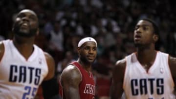 Dec 1, 2013; Miami, FL, USA; Miami Heat small forward LeBron James (6) reacts behind Charlotte Bobcats center Al Jefferson (25) and small forward Michael Kidd-Gilchrist (14) in the second half at American Airlines Arena. The Heat won 99-98. Mandatory Credit: Robert Mayer-USA TODAY Sports