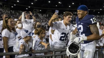 STATE COLLEGE, PA - SEPTEMBER 18: Brandon Smith #12 of the Penn State Nittany Lions celebrates with fans after the game against the Auburn Tigers at Beaver Stadium on September 18, 2021 in State College, Pennsylvania. (Photo by Scott Taetsch/Getty Images)