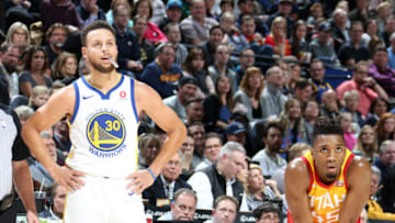 SALT LAKE CITY, UT - JANUARY 30: Donovan Mitchell #45 of the Utah Jazz and Stephen Curry #30 of the Golden State Warriors looks on during the game on January 30, 2018 at vivint.SmartHome Arena in Salt Lake City, Utah. Copyright 2018 NBAE (Photo by Melissa Majchrzak/NBAE via Getty Images)