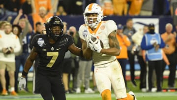 Dec 30, 2021; Nashville, TN, USA; Tennessee Volunteers wide receiver Cedric Tillman (4) scores a touchdown past Purdue Boilermakers cornerback Jamari Brown (7) during the second half at Nissan Stadium. Mandatory Credit: Steve Roberts-USA TODAY Sports
