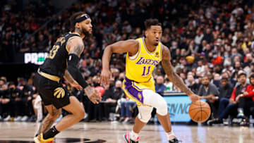 TORONTO, ON - MARCH 18: Malik Monk #11 of the Los Angeles Lakers drives to the net against Gary Trent Jr. #33 of the Toronto Raptors (Photo by Cole Burston/Getty Images)