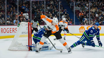 Oct 28, 2021; Vancouver, British Columbia, CAN; Vancouver Canucks defenseman Oliver Ekman-Larsson (23) looks on as Philadelphia Flyers forward James van Riemsdyk (25) redirects the puck on goalie Jaroslav Halak (41) in the second period at Rogers Arena. Mandatory Credit: Bob Frid-USA TODAY Sports