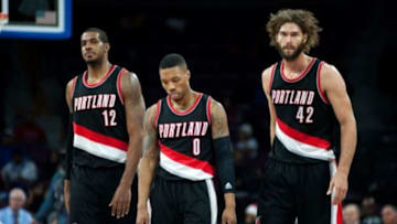 Dec 9, 2014; Auburn Hills, MI, USA; Portland Trail Blazers forward LaMarcus Aldridge (12) guard Damian Lillard (0) and center Robin Lopez (42) during the fourth quarter against the Detroit Pistons at The Palace of Auburn Hills. Portland won 98-86. Mandatory Credit: Tim Fuller-USA TODAY Sports