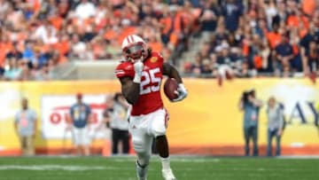 Jan 1, 2015; Tampa, FL, USA; Wisconsin Badgers running back Melvin Gordon (25) runs with the ball against the Auburn Tigers during the first half in the 2015 Outback Bowl at Raymond James Stadium. Mandatory Credit: Kim Klement-USA TODAY Sports