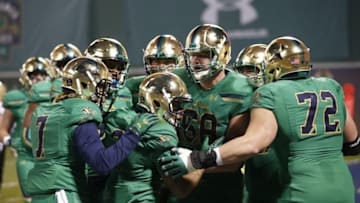 Nov 21, 2015; Boston, MA, USA; Notre Dame Fighting Irish wide receiver Amir Carlisle (3) celebrates a touchdown surrounded by teammates during the first quarter against the Boston College Eagles at Fenway Park. Mandatory Credit: Greg M. Cooper-USA TODAY Sports
