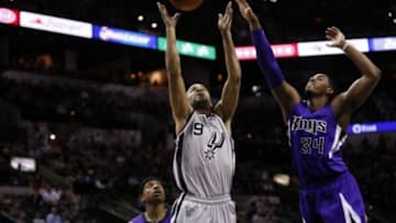 Feb 1, 2014; San Antonio, TX, USA; San Antonio Spurs guard Tony Parker (9) drives to the basket as Sacramento Kings forward Jason Thompson (34) defends during the first half at AT&T Center. Mandatory Credit: Soobum Im-USA TODAY Sports