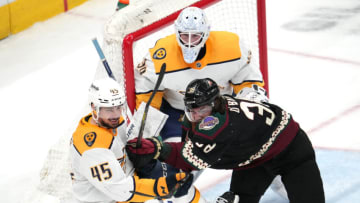 Apr 29, 2022; Glendale, Arizona, USA; Arizona Coyotes center Liam O'Brien (38) and Nashville Predators defenseman Alexandre Carrier (45) battle for position in front of Nashville Predators goaltender Connor Ingram (39) during the third period at Gila River Arena. Mandatory Credit: Joe Camporeale-USA TODAY Sports