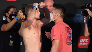 ABU DHABI, UNITED ARAB EMIRATES - OCTOBER 02: In this handout image provided by UFC, (L-R) Opponents Casey Kenney and Alatengheili of China face off during the UFC Fight Night weigh-in on October 02, 2020 in Abu Dhabi, United Arab Emirates. (Photo by Josh Hedges/Zuffa LLC via Getty Images)