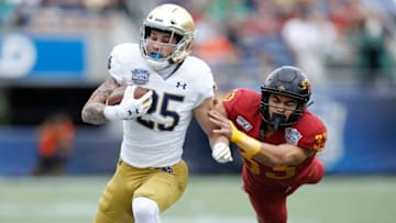 ORLANDO, FL - DECEMBER 28: Braden Lenzy #25 of the Notre Dame Fighting Irish runs with the ball after catching a pass against Braxton Lewis #33 of the Iowa State Cyclones in the first half of the Camping World Bowl at Camping World Stadium on December 28, 2019 in Orlando, Florida. (Photo by Joe Robbins/Getty Images)
