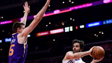 LOS ANGELES, CA - DECEMBER 20: Milos Teodosic #4 of the LA Clippers passes around Alan Williams #15 of the Phoenix Suns during the first half at Staples Center on December 20, 2017 in Los Angeles, California. (Photo by Harry How/Getty Images)