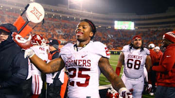 Nov 28, 2015; Stillwater, OK, USA; Oklahoma Sooners running back Joe Mixon (25) celebrates on the sidelines in the fourth quarter against the Oklahoma State Cowboys at Boone Pickens Stadium. The Sooners defeated the Cowboys 58-23. Mandatory Credit: Mark J. Rebilas-USA TODAY Sports