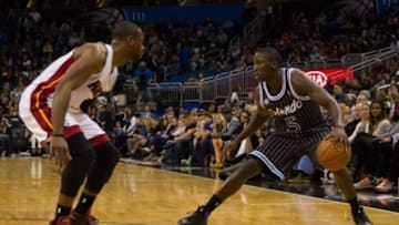 Jan 4, 2014; Orlando, FL, USA; Miami Heat shooting guard Dwyane Wade (3) defends Orlando Magic shooting guard Victor Oladipo (5) during the second half of the game at the Amway Center. Mandatory Credit: Rob Foldy-USA TODAY Sports