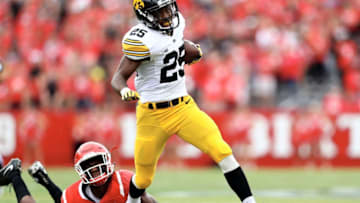 PISCATAWAY, NJ - SEPTEMBER 24: Akrum Wadley #25 of the Iowa Hawkeyes carries the ball as Trevor Morris #15 of the Rutgers Scarlet Knights defends at High Point Solutions Stadium on September 24, 2016 in Piscataway, New Jersey. (Photo by Elsa/Getty Images)
