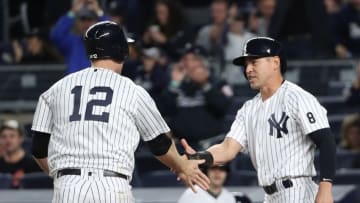 Oct 1, 2016; Bronx, NY, USA; New York Yankees third baseman Chase Headley (12) and center fielder Jacoby Ellsbury (22) celebrate scoring during the eighth inning against the Baltimore Orioles at Yankee Stadium. New York Yankees won 7-3. Mandatory Credit: Anthony Gruppuso-USA TODAY Sports