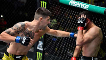 LAS VEGAS, NEVADA - NOVEMBER 13: (L-R) Joel Alvarez of Spain punches Thiago Moises of Brazil in a lightweight fight during the UFC Fight Night event at UFC APEX on November 13, 2021 in Las Vegas, Nevada. (Photo by Chris Unger/Zuffa LLC)