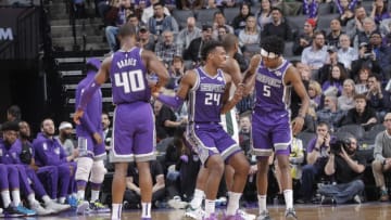 SACRAMENTO, CA - FEBRUARY 27: Harrison Barnes #40 and De'Aaron Fox #5 of the Sacramento Kings help up teammate Buddy Hield #24 during the game against the Milwaukee Bucks on February 27, 2019 at Golden 1 Center in Sacramento, California. NOTE TO USER: User expressly acknowledges and agrees that, by downloading and or using this photograph, User is consenting to the terms and conditions of the Getty Images Agreement. Mandatory Copyright Notice: Copyright 2019 NBAE (Photo by Rocky Widner/NBAE via Getty Images)
