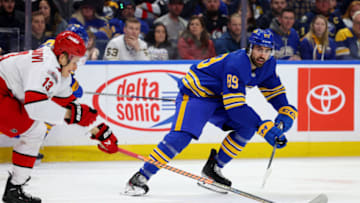 Apr 8, 2023; Buffalo, New York, USA; Carolina Hurricanes right wing Jesse Puljujarvi (13) tries to block a pass by Buffalo Sabres right wing Alex Tuch (89) during the first period at KeyBank Center. Mandatory Credit: Timothy T. Ludwig-USA TODAY Sports