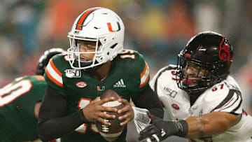 MIAMI, FLORIDA - NOVEMBER 09: Jarren Williams #15 of the Miami Hurricanes is sacked by Dayna Kinnaird #57 of the Louisville Cardinals during the second half at Hard Rock Stadium on November 09, 2019 in Miami, Florida. (Photo by Michael Reaves/Getty Images)