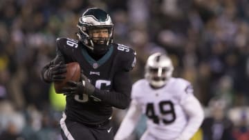 PHILADELPHIA, PA - DECEMBER 25: Derek Barnett #96 of the Philadelphia Eagles picks up a fumble and runs past Jamize Olawale #49 of the Oakland Raiders to score a touchdown as time expired at Lincoln Financial Field on December 25, 2017 in Philadelphia, Pennsylvania. The Eagles defeated the Raiders 19-10. (Photo by Mitchell Leff/Getty Images)