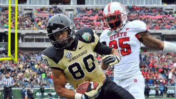 Dec 31, 2012; Nashville, TN, USA; Vanderbilt Commodores wide receiver Chris Boyd (80) catches a pass for a touchdown against North Carolina State Wolfpack safety Dontae Johnson (25) during the first half of the Music City Bowl at LP Field. Mandatory Credit: Jim Brown-USA TODAY Sports