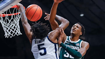 INDIANAPOLIS, IN - NOVEMBER 17: Myles Wilmoth #5 of the Butler Bulldogs has his shot blocked by Marcus Bingham Jr. #30 of the Michigan State Spartans during the game at Hinkle Fieldhouse on November 17, 2021 in Indianapolis, Indiana. (Photo by Michael Hickey/Getty Images)