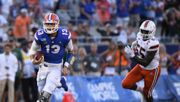 ORLANDO, FL - AUGUST 24: Feleipe Franks #13 of the Florida Gators runs for a first down in the first half against the Miami Hurricanes in the Camping World Kickoff at Camping World Stadium on August 24, 2019 in Orlando, Florida.(Photo by Mark Brown/Getty Images)