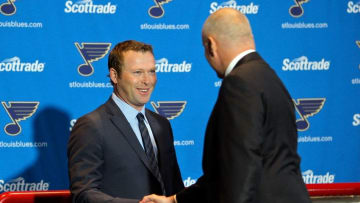 Jan 29, 2015; St. Louis, MO, USA; Martin Brodeur (left) shakes the hand of Saint Louis Blues general manager Doug Armstrong as Brodeur steps to the podium to announce his retirement from the NHL during a press conference at Scottrade Center. Mandatory Credit: Scott Kane-USA TODAY Sports