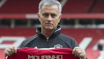 Manchester United's new Portuguese manager Jose Mourinho poses with a scarf on the pitch during a photocall at Old Trafford stadium in Manchester, northern England, on July 5, 2016.Jose Mourinho officially started work as Manchester United manager at the club's Carrington training base yesterday. The 53-year-old was appointed as United boss in May after the sacking of Dutchman Louis van Gaal. / AFP / OLI SCARFF (Photo credit should read OLI SCARFF/AFP/Getty Images)