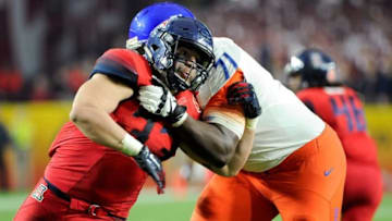 Dec 31, 2014; Glendale, AZ, USA; Arizona Wildcats linebacker Scooby Wright III (33) defends Boise State Broncos offensive lineman Rees Odhiambo (71) during the third quarter in the 2014 Fiesta Bowl at Phoenix Stadium. The Broncos won 38-30. Mandatory Credit: Casey Sapio-USA TODAY Sports
