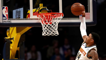 DENVER, COLORADO - NOVEMBER 05: Gary Harris #14 of the Denver Nuggets dunks against Meyers Leonard #0 of the Miami Heat in the first quarter at the Pepsi Center on November 05, 2019 in Denver, Colorado. NOTE TO USER: User expressly acknowledges and agrees that, by downloading and or using this photograph, User is consenting to the terms and conditions of the Getty Images License Agreement. (Photo by Matthew Stockman/Getty Images)