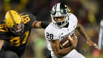 MINNEAPOLIS, MN - OCTOBER 14: Madre London #28 of the Michigan State Spartans carries the ball against Yale Van Dyne #87 of the Minnesota Golden Gophers during the third quarter of the game on October 14, 2017 at TCF Bank Stadium in Minneapolis, Minnesota. The Spartans defeated the Gophers 30-27. (Photo by Hannah Foslien/Getty Images)