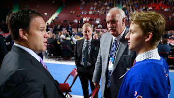 VANCOUVER, BRITISH COLUMBIA - JUNE 22: Zachary Jones, 68th overall pick of the New York Rangers, speaks with general manager Jeff Gorton at the team draft table during Rounds 2-7 of the 2019 NHL Draft at Rogers Arena on June 22, 2019 in Vancouver, Canada. (Photo by Jeff Vinnick/NHLI via Getty Images)