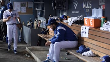 LOS ANGELES, CALIFORNIA - OCTOBER 09: (EDITOR'S NOTE: Alternative crop) Joe Kelly #17 of the Los Angeles Dodgers walks in the dugout after being pulled as Clayton Kershaw #22 sits dejected on the bench in the tenth inning of game five of the National League Division Series against the Washington Nationals at Dodger Stadium on October 09, 2019 in Los Angeles, California. (Photo by Harry How/Getty Images)