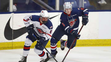 PLYMOUTH, MICHIGAN - JANUARY 17: Brady Berard #8 of Team White skates the puck from out of the corner against Sam Rinzel #6 of Team Blue in the second period of the USA Hockey All-American Game at USA Hockey Arena on January 17, 2022 in Plymouth, Michigan. (Photo by Mike Mulholland/Getty Images)