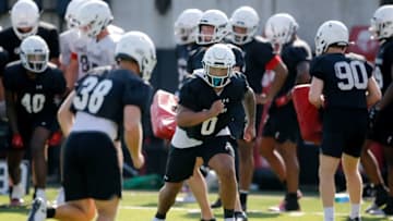 Bearcats linebacker Ivan Pace Jr. runs through a drill during the first day of training camp. The Enquirer.