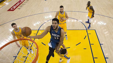 April 5, 2016; Oakland, CA, USA; Minnesota Timberwolves center Karl-Anthony Towns (32) commits an offensive foul charging into Golden State Warriors guard Stephen Curry (30) during the second half at Oracle Arena. The Timberwolves defeated the Warriors 124-117. Mandatory Credit: Kyle Terada-USA TODAY Sports