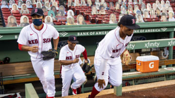 BOSTON, MA - AUGUST 18: Tzu-Wei Lin #30, Rafael Devers #11, and Xander Bogaerts #2 of the Boston Red Sox run out of the dugout before a game against the Philadelphia Phillies on August 18, 2020 at Fenway Park in Boston, Massachusetts. The 2020 season had been postponed since March due to the COVID-19 pandemic. (Photo by Billie Weiss/Boston Red Sox/Getty Images)
