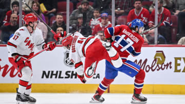 MONTREAL, CANADA - MARCH 07: Josh Anderson #17 of the Montreal Canadiens takes down Shayne Gostisbehere #41 of the Carolina Hurricanes during the second period at Centre Bell on March 7, 2023 in Montreal, Quebec, Canada. (Photo by Minas Panagiotakis/Getty Images)