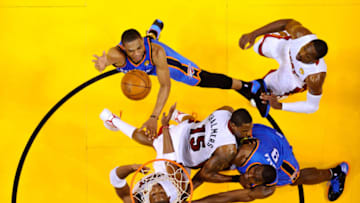 OKC Thunder drives for a shot attempt against Chris Bosh #1. (Photo by Larry W. Smith-Pool/Getty Images)