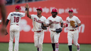PHILADELPHIA, PA - JULY 4: Cesar Hernandez #16, Nick Williams #5, Odubel Herrera #37, and Rhys Hoskins #17 of the Philadelphia Phillies high five after the game against the Baltimore Orioles at Citizens Bank Park on July 4, 2018 in Philadelphia, Pennsylvania. The Phillies defeated the Orioles 4-1. (Photo by Mitchell Leff/Getty Images)