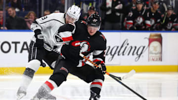 Dec 13, 2022; Buffalo, New York, USA; Los Angeles Kings right wing Adrian Kempe (9) and Buffalo Sabres center Casey Mittelstadt (37) look to control the puck during the second period at KeyBank Center. Mandatory Credit: Timothy T. Ludwig-USA TODAY Sports