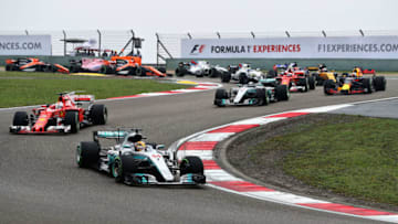 SHANGHAI, CHINA - APRIL 09: Lewis Hamilton of Great Britain driving the (44) Mercedes AMG Petronas F1 Team Mercedes F1 WO8 leads Sebastian Vettel of Germany driving the (5) Scuderia Ferrari SF70H and the rest of the field into turn 3 at the start during the Formula One Grand Prix of China at Shanghai International Circuit on April 9, 2017 in Shanghai, China. (Photo by Mark Thompson/Getty Images)
