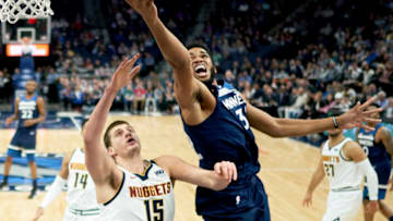 Karl-Anthony Towns of the Minnesota Timberwolves shoots the ball against Nikola Jokic of the Denver Nuggets. (Photo by Hannah Foslien/Getty Images)