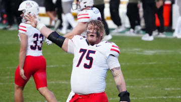 Nov 11, 2023; Boulder, Colorado, USA; Arizona Wildcats offensive lineman Josh Baker (75) celebrates after defeating the Colorado Buffaloes at Folsom Field. Mandatory Credit: Ron Chenoy-USA TODAY Sports