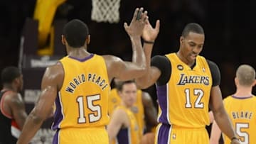 Feb 22, 2013; Los Angeles, CA, USA; Los Angeles Lakers small forward Metta World Peace (15) high fives center Dwight Howard (12) during the game against the Portland Trail Blazers at the Staples Center. Mandatory Credit: Richard Mackson-USA TODAY Sports