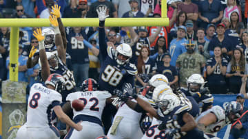 CARSON, CA - NOVEMBER 18: Denver Broncos kicker Brandon McManus #8 kicks the game winner out of the hold of Denver Broncos punter Colby Wadman #3 as Los Angeles Chargers defenders try to block the kick in the second half of the game at StubHub Center in Carson on Sunday, November 18, 2018. (Photo by Terry Pierson/Digital First Media/The Press-Enterprise via Getty Images)