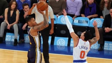 Nov 14, 2014; New York, NY, USA; Utah Jazz point guard Trey Burke (3) shoots over New York Knicks point guard Shane Larkin (0) during the first quarter at Madison Square Garden. Mandatory Credit: Brad Penner-USA TODAY Sports