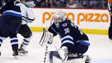 Feb 2, 2016; Winnipeg, Manitoba, CAN; Winnipeg Jets goalie Connor Hellebuyck (30) makes a save during the third period against the Dallas Stars at the MTS Centre. Dallas wins 5-3. Mandatory Credit: Bruce Fedyck-USA TODAY Sports