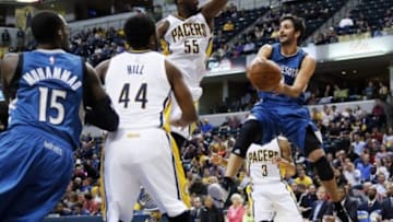 Oct 7, 2014; Indianapolis, IN, USA; Minnesota Timberwolves guard Ricky Rubio (9) makes a pass against Indiana Pacers center Roy Hibbert (55) at Bankers Life Fieldhouse. Mandatory Credit: Brian Spurlock-USA TODAY Sports
